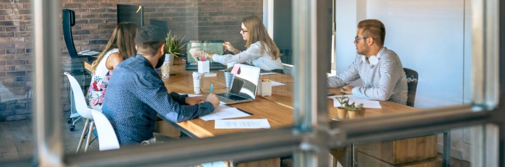 Team arbeitet gemeinsam in modernem Büro – exzellenter Kundenservice und engagierte Betreuung durch erfahrene Rechtsschutzberater.